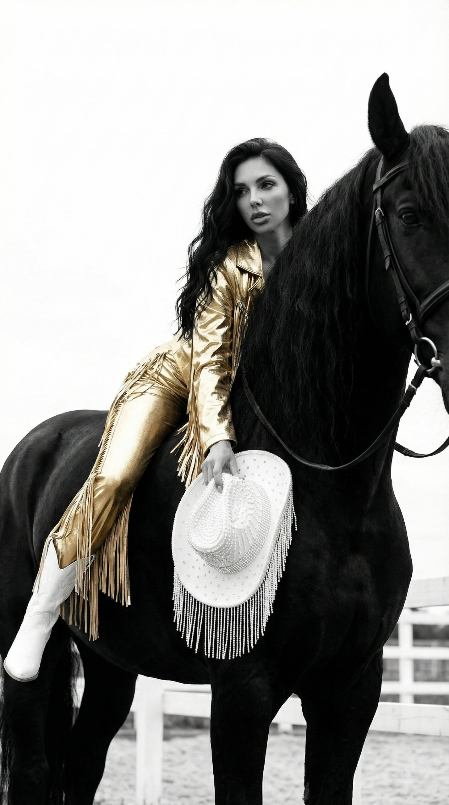 Fashion model posing on horse wearing black outfit and boots in minimalist western fashion editorial.