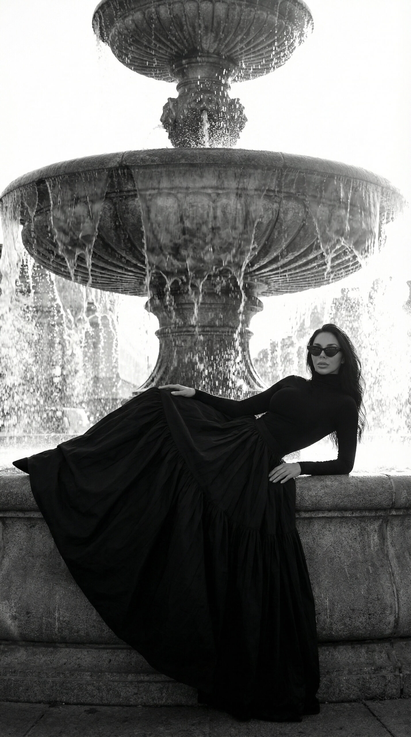 Fashion model in elegant black dress walking near Eiffel Tower in Paris editorial fashion photoshoot